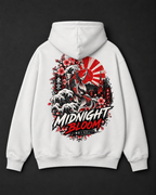 A white pullover hoodie shown from the back, featuring a large graphic print with a Japanese wave, cherry blossoms, a red sun motif, and the text 'MIDNIGHT BLOOM'.